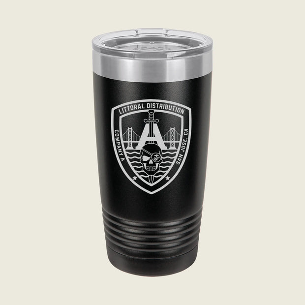 A black insulated travel tumbler with a clear lid, featuring a white and gray shield emblem on the front that reads 'Litoral Distribution' with a bridge and skull graphic, set against a light beige background.