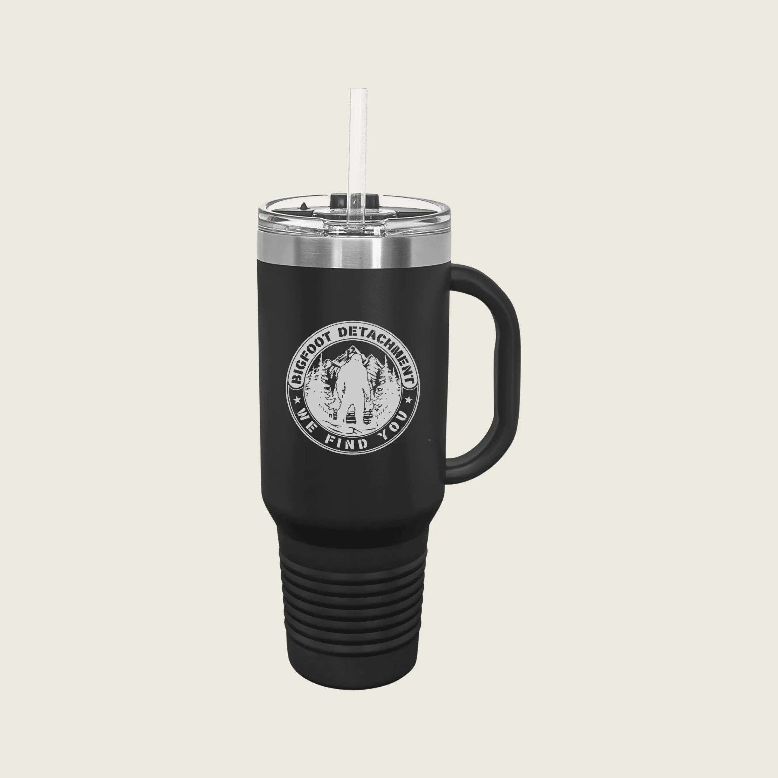 black travel mug with bigfoot logo engraved on beige background