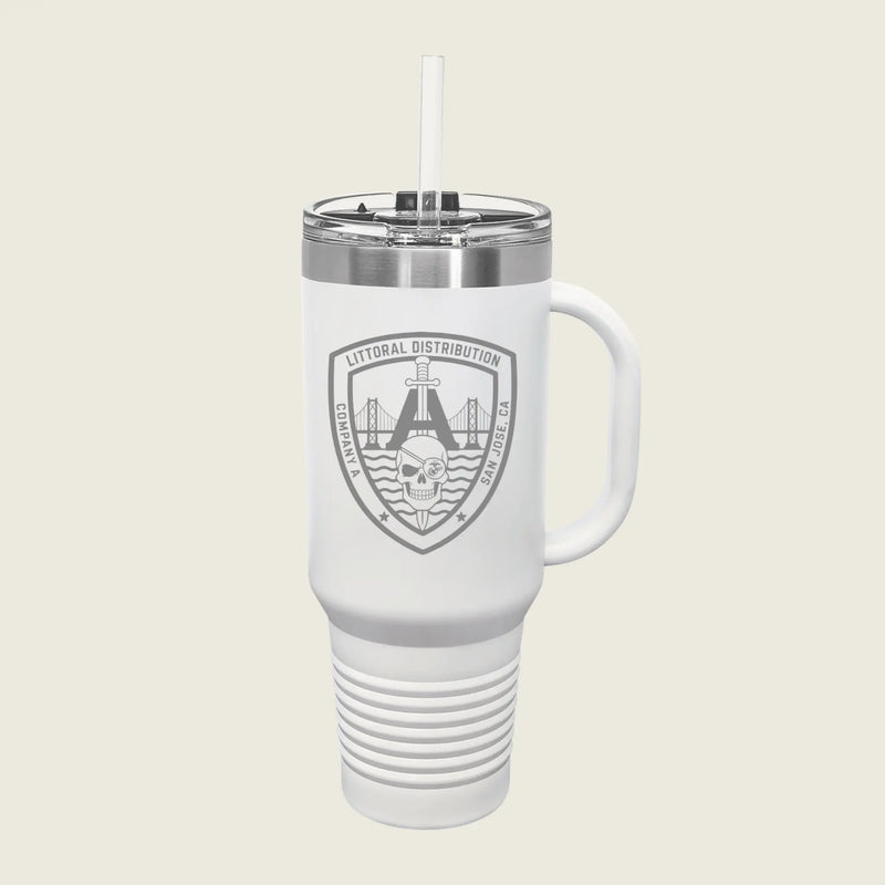 A white insulated travel tumbler with a handle, clear lid, and straw, featuring a gray shield logo that reads 'LITORAL DISTRIBUTION' with a bridge and skull graphic, on a light beige background.