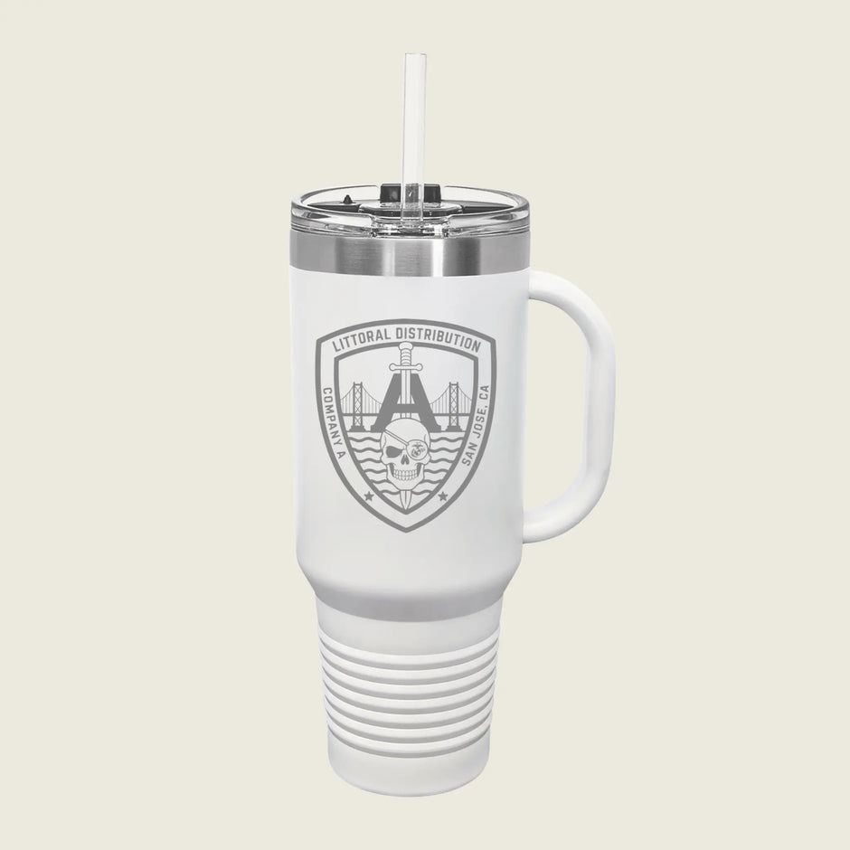 A white insulated travel tumbler with a handle, clear lid, and straw, featuring a gray shield logo that reads 'LITORAL DISTRIBUTION' with a bridge and skull graphic, on a light beige background.