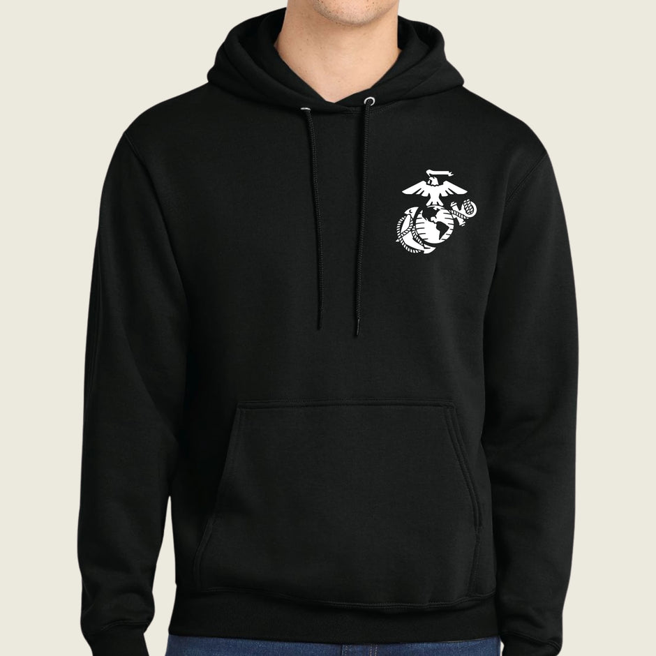 Black hoodie with a white logo on a beige background