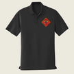 Black polo shirt with a colorful logo on a beige background