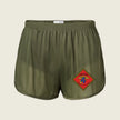 Green shorts with a red and yellow emblem on a beige background