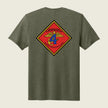Green t-shirt with a colorful emblem on the back against a beige background