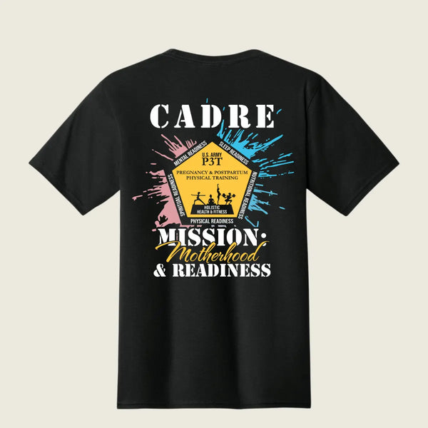 A black short-sleeve t-shirt shown from the back, featuring a colorful graphic print with the text 'CADRE' and 'MISSION: Motherhood & Readiness' in white and yellow, surrounded by blue and pink paint splatter details.