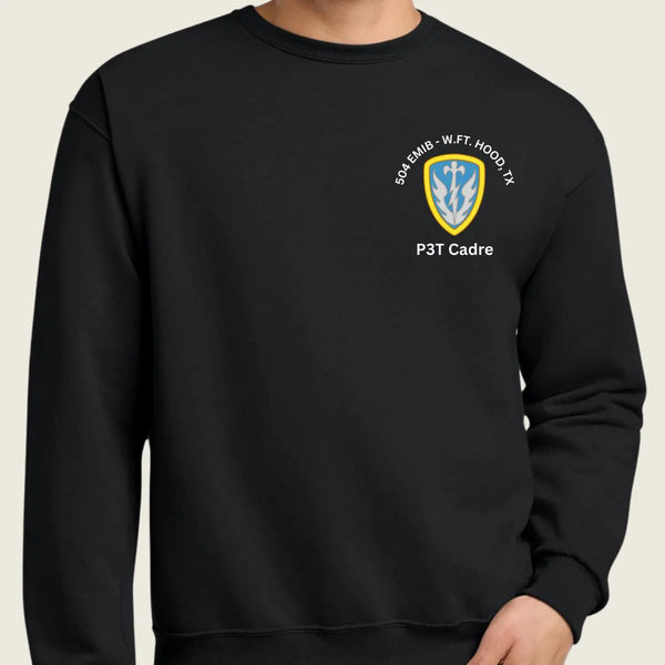 A person wearing a black crewneck sweatshirt with a small military logo and text on the left chest 