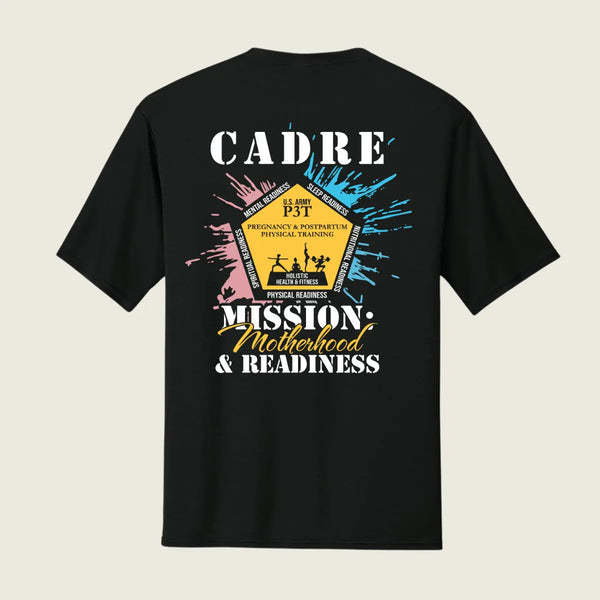 A black short-sleeve t-shirt shown from the back, featuring a large graphic print with the text 'CADRE' and 'MISSION: Motherhood & Readiness' in white and yellow, surrounded by pink, blue, and yellow paint splatters.