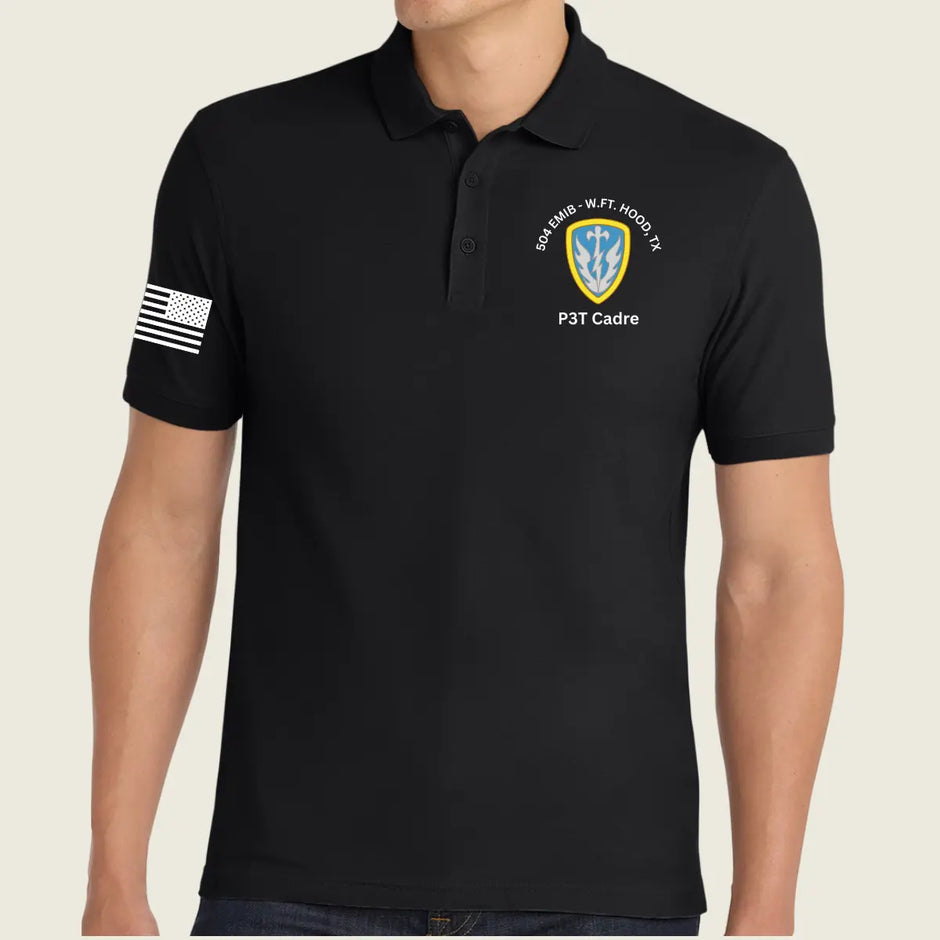 A man wearing a black short-sleeve polo shirt with a white American flag patch on the right sleeve and a white and yellow crest patch on the left chest reading '504th Bn, WFT, HOOT TX' and 'P3T Cadre'.