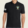 A man wearing a black short-sleeve polo shirt with a white American flag patch on the right sleeve and a white and yellow crest patch on the left chest reading '504th Bn, WFT, HOOT TX' and 'P3T Cadre'.