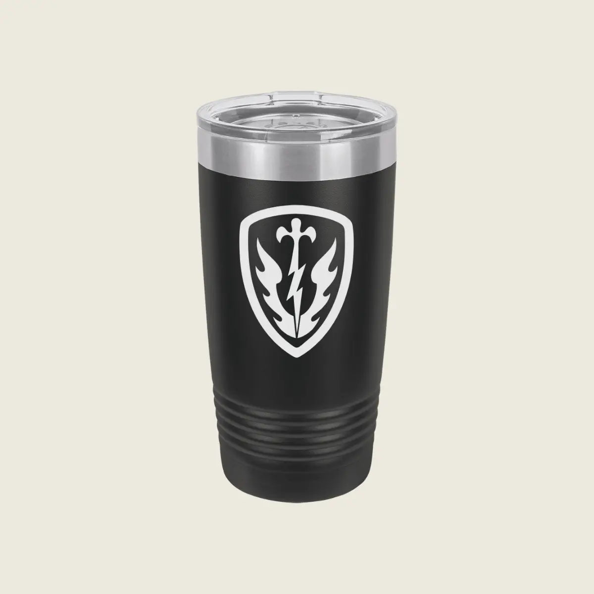 A black insulated travel tumbler with a clear lid, featuring a white shield emblem with a lightning bolt and leaf design on the front, set against a solid light beige background.