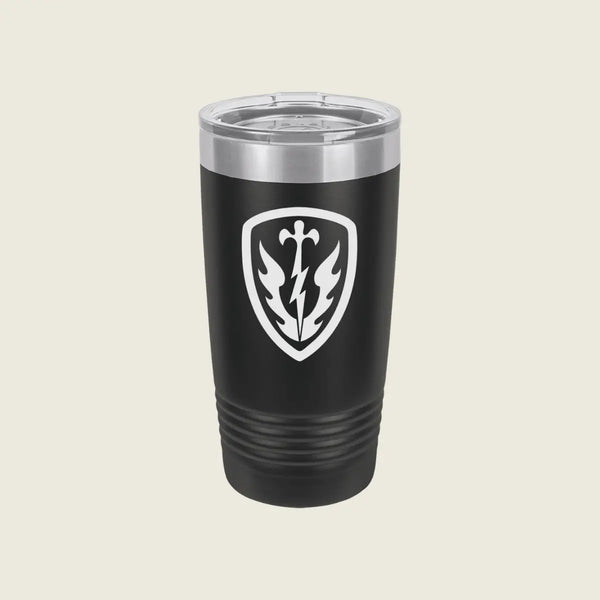 A black insulated travel tumbler with a clear lid, featuring a white shield emblem with a lightning bolt and leaf design on the front, set against a solid light beige background.