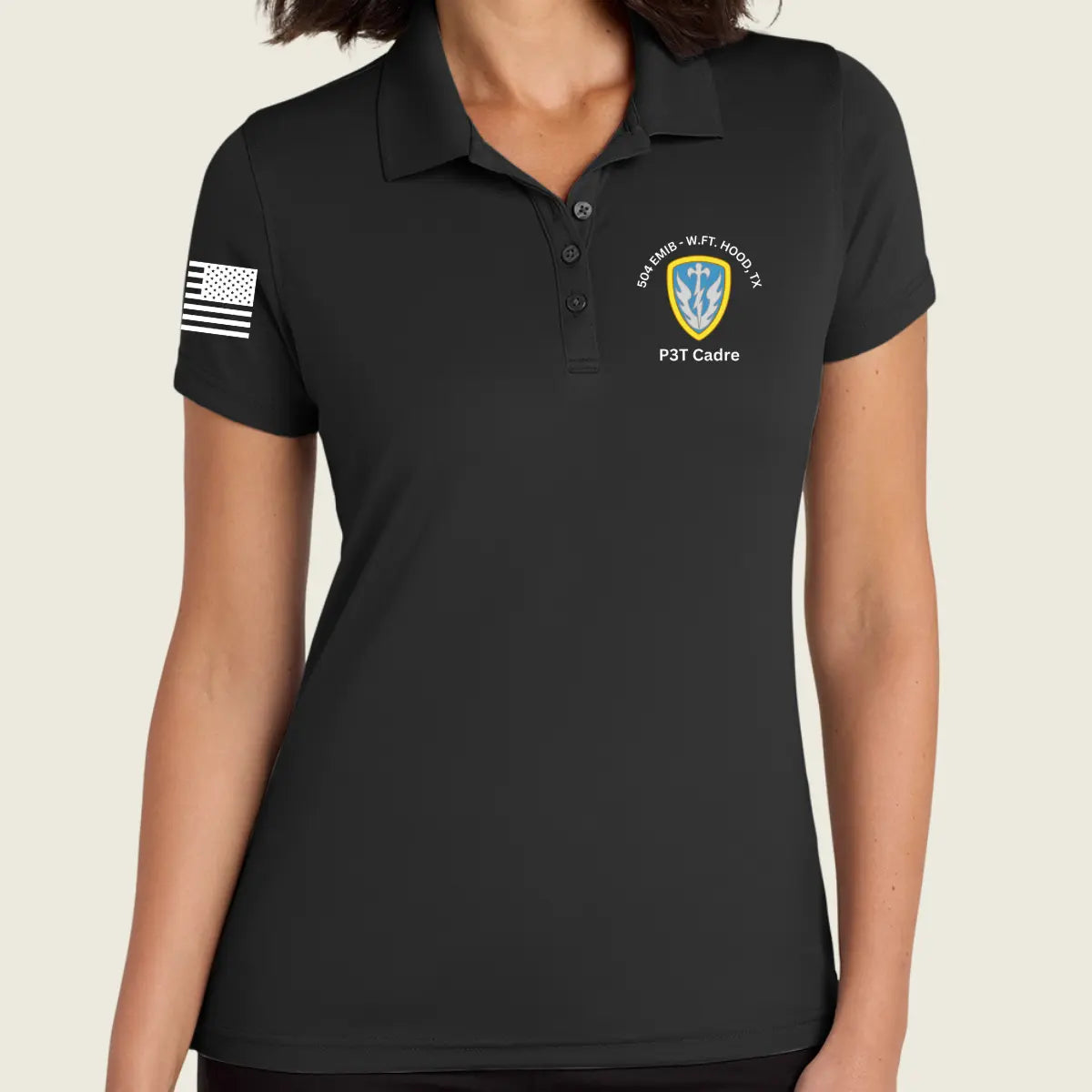 A woman wearing a black short-sleeve polo shirt with a black-and-white American flag patch on the right sleeve and a military-style crest on the left chest reading P3T Cadre.