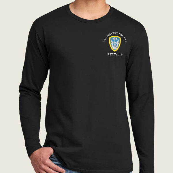 A man wearing a black long-sleeve t-shirt with a small P3T Cadre emblem printed on the left chest, set against a solid light beige background.