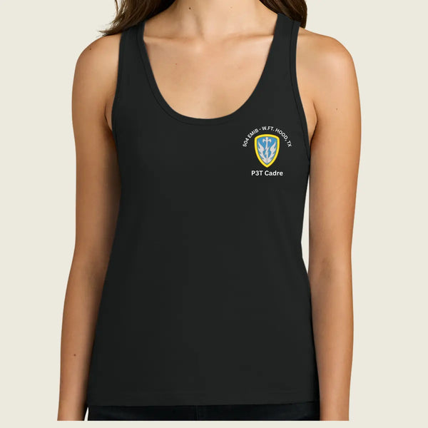 A woman wearing a black sleeveless tank top with a small white and blue crest graphic on the left chest, photographed against a plain light beige background.