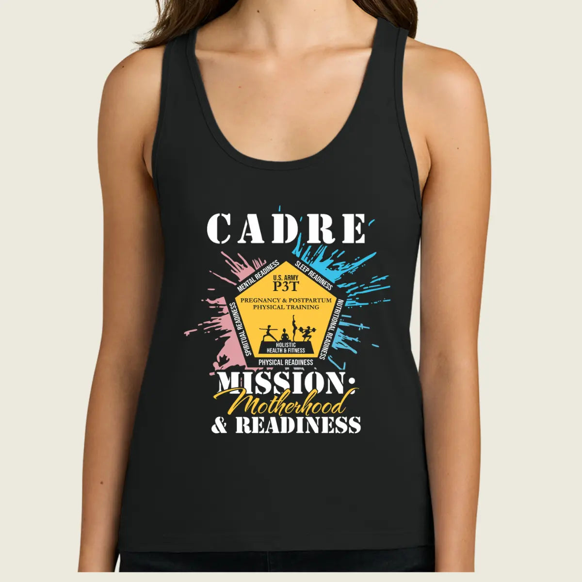 A woman wearing a black racerback tank top with a colorful graphic print on the front. The graphic features the text 'CADRE MISSION, Motherhood & READINESS' with a central yellow badge illustration and blue, pink, and white paint splatter details.