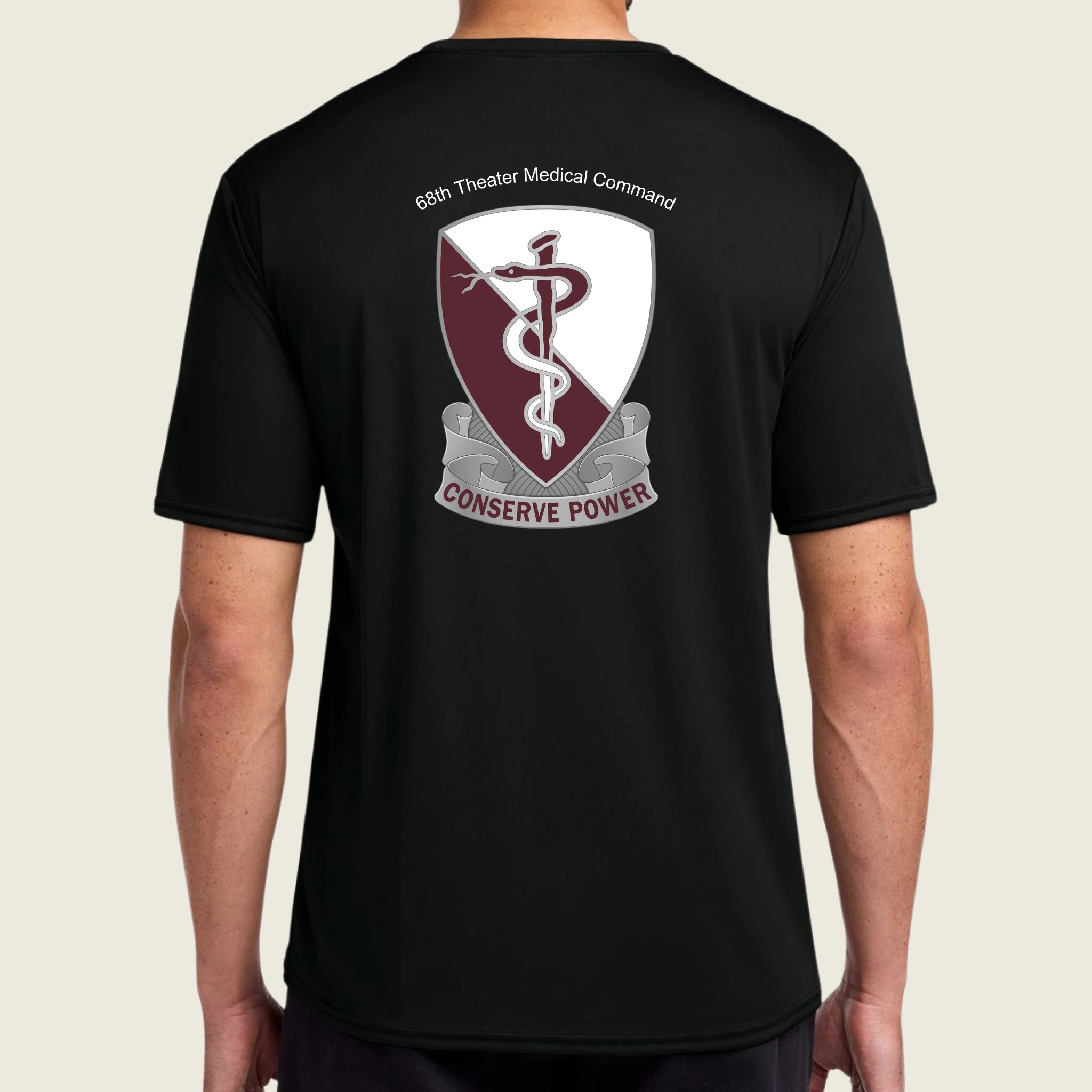 Black t-shirt with a medical emblem and text on the back, worn by a person.