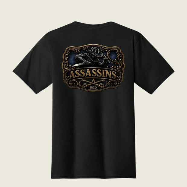 A black short-sleeve t-shirt shown from the back, featuring a large graphic print of a raven holding a knife inside an ornate frame, with the word 'ASSASSINS' and '163D' printed below in gold and brown tones.