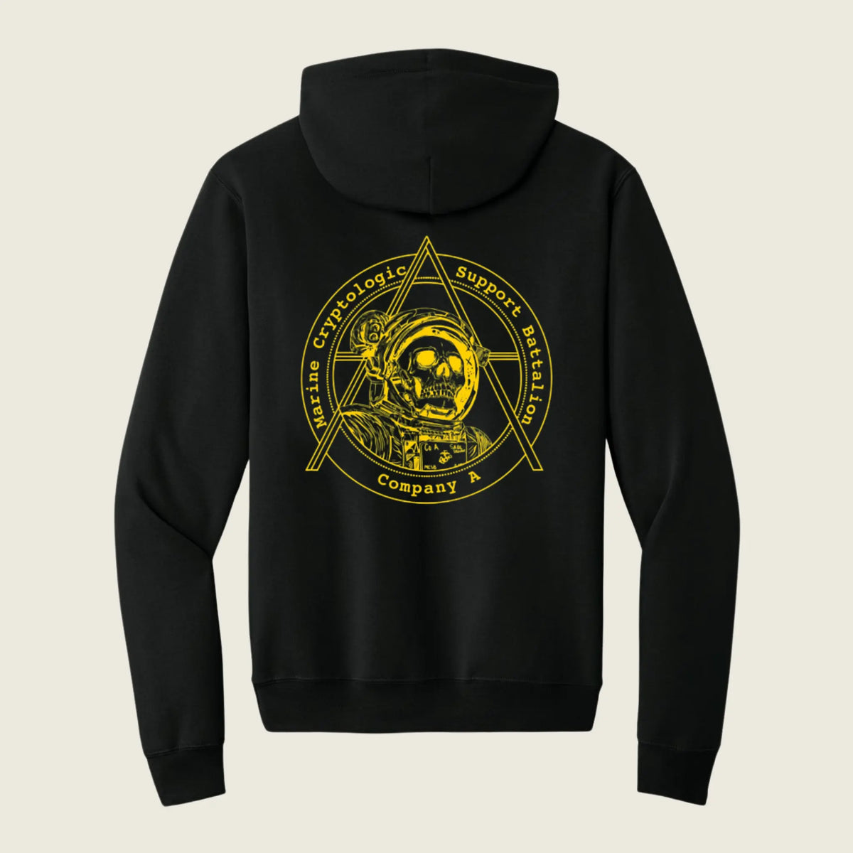 A black pullover hoodie shown from the back, featuring a large yellow graphic print of an astronaut inside a triangle emblem with the text 'Marine Cryptologic Support Mission Company A' on a light beige background.
