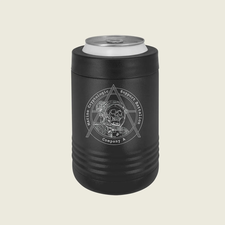 A black insulated can cooler sleeve with a silver aluminum can inserted, featuring a white circular graphic of a skull inside a triangle with the text 'Masonic Theologic Support Battalion Company X'. The product is shown on a solid light beige background.