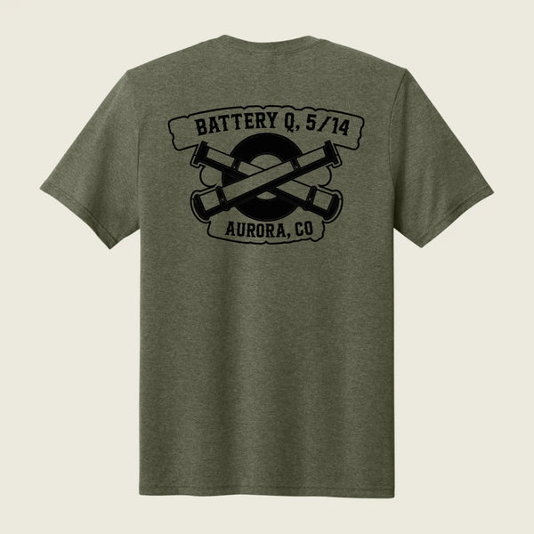 An olive green heather short-sleeve t-shirt shown from the back, featuring a black graphic print of crossed artillery shells with the text 'BATTERY Q, 5/14' and 'AURORA, CO'.