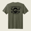 An olive green heather short-sleeve t-shirt shown from the back, featuring a black graphic print of crossed artillery shells with the text 'BATTERY Q, 5/14' and 'AURORA, CO'.