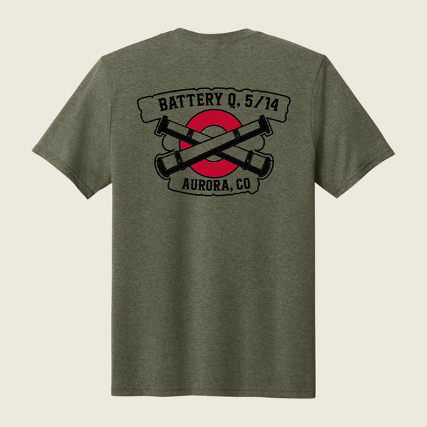 A heather olive green short-sleeve t-shirt shown from the back, featuring a graphic print of crossed black cannons over a red circle with banners reading 'BATTERY Q, 5/14' and 'AURORA, CO'.