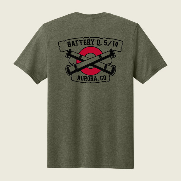 A heather olive green short-sleeve t-shirt shown from the back, featuring a graphic print of crossed black cannons over a red circle with banners reading 'BATTERY Q, 5/14' and 'AURORA, CO'.
