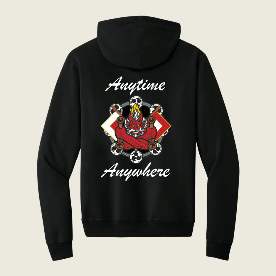 A black pullover hoodie shown from the back, featuring a graphic design with the words 'Anytime Anywhere' in white script and a central red and black dragon illustration with wheels and a skull.