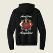 A black pullover hoodie shown from the back, featuring a graphic design with the words 'Anytime Anywhere' in white script and a central red and black dragon illustration with wheels and a skull.