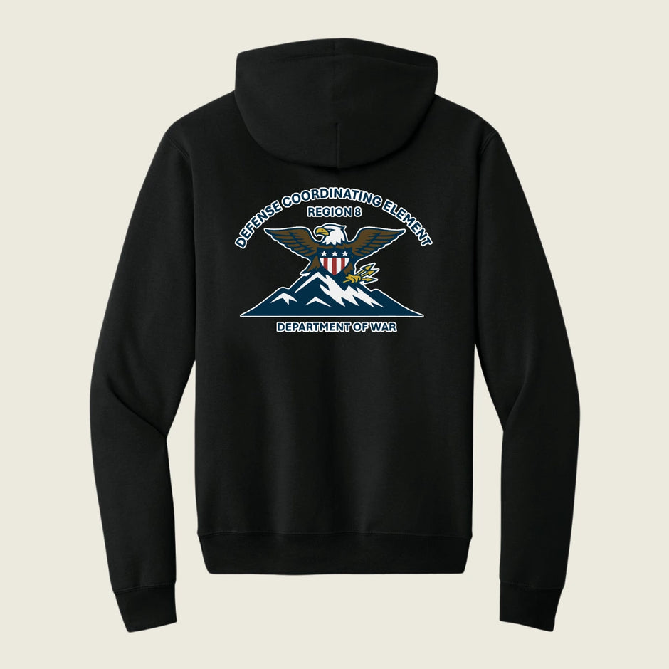 A black pullover hoodie shown from the back, featuring a large graphic print of an eagle over mountains with the text 'DEFENSE COORDINATING ELEMENT REGION 6 DEPARTMENT OF WAR' in white and blue.