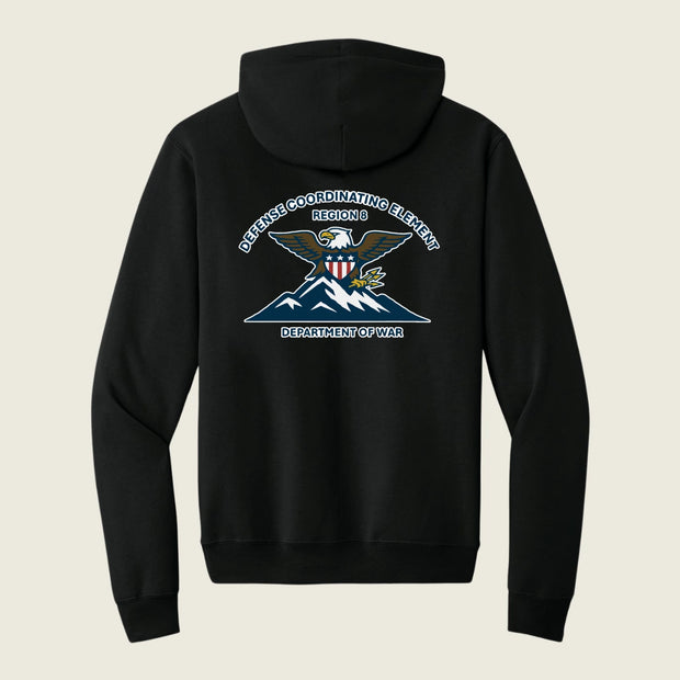 A black pullover hoodie shown from the back, featuring a large graphic print of an eagle over mountains with the text 'DEFENSE COORDINATING ELEMENT REGION 6 DEPARTMENT OF WAR' in white and blue.