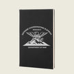 black journal with engraved logo on front