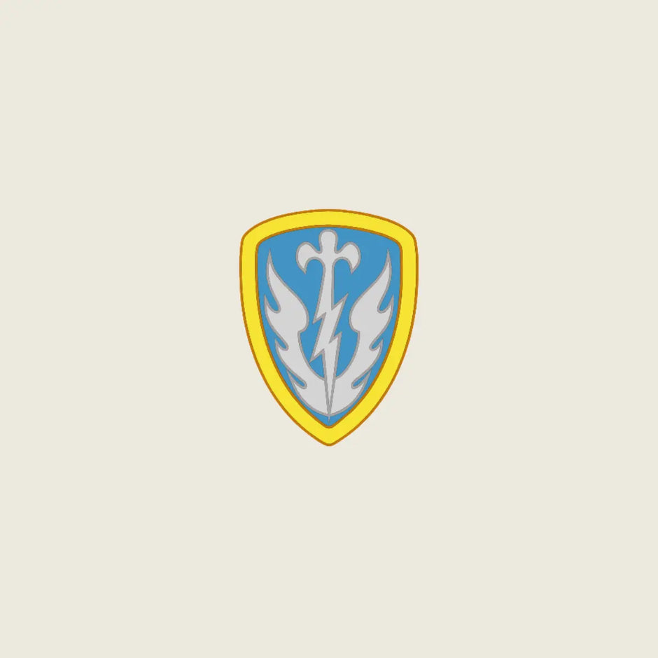 A shield-shaped emblem with a yellow border, light blue center, and a white stylized bird or flame motif, centered on a plain light beige background.