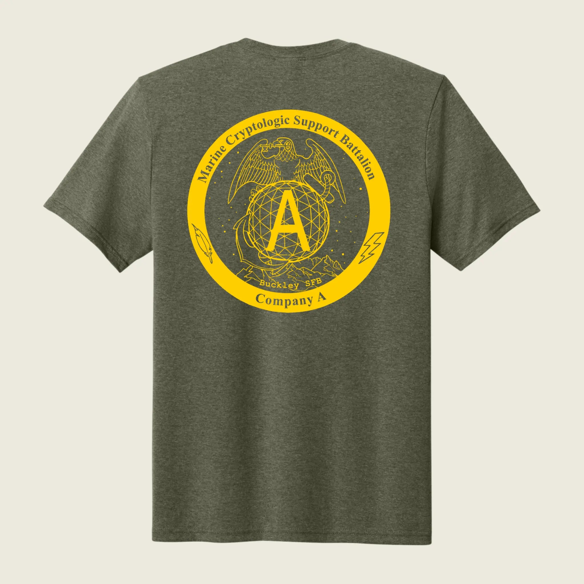 A heather olive green t-shirt shown from the back, featuring a large yellow circular graphic print with the USMC Eagle, Globe, and Anchor emblem and the text 'Marine Cryptologic Support Battalion Company A'.