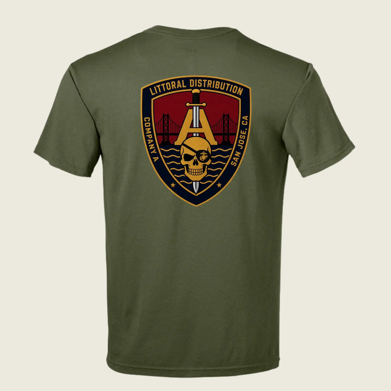 An olive green short-sleeve t-shirt shown from the back, featuring a large military-style shield patch graphic on the upper back with a skull, bridge, and text reading 'LITTORAL DISTRIBUTION' and 'COMPACT SAN JOSE CA'.