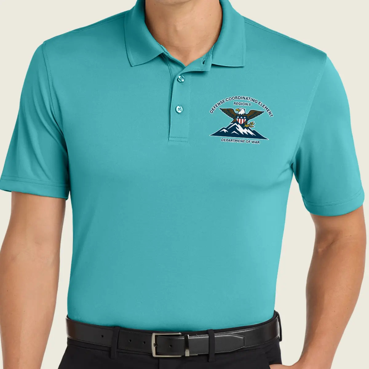 A man wearing a turquoise short-sleeve polo shirt with logo paired with a black belt.