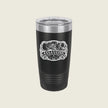 A black insulated travel tumbler with a clear lid and a white 'Assassins' graphic on the front, set against a solid light beige background.