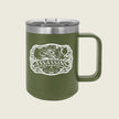 An olive green insulated travel mug with a stainless steel lid and a white 'Assassins' graphic on the front, set against a solid light beige background.
