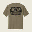 Assassins logo printed on the back of a coyote brown shirt 