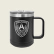 A matte black insulated travel mug with a clear plastic lid and a black handle, featuring a white printed shield logo on the front that reads 'LITTORAL DISTRIBUTION' with a bridge, skull, and wave design. The mug is photographed against a solid, light beige background.