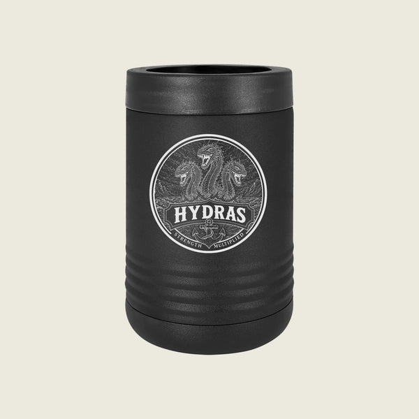 A matte black insulated can cooler with a matching lid, featuring a circular silver graphic of three lions and the brand name 'HYDRAS' on the front, set against a solid light beige background.