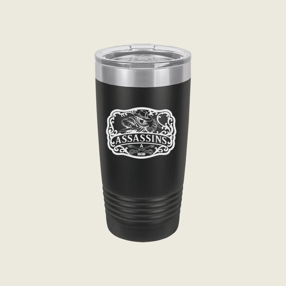 A black insulated travel tumbler with a clear lid, featuring a white 'Assassins & 1920' graphic on the front, set against a solid light beige background.