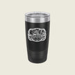 A black insulated travel tumbler with a clear lid, featuring a white 'Assassins & 1920' graphic on the front, set against a solid light beige background.