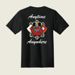 A black short-sleeve t-shirt shown from the back, featuring a graphic of a red demon riding a skateboard with flames, surrounded by white text that reads 'Anytime Anywhere' on a light beige background.