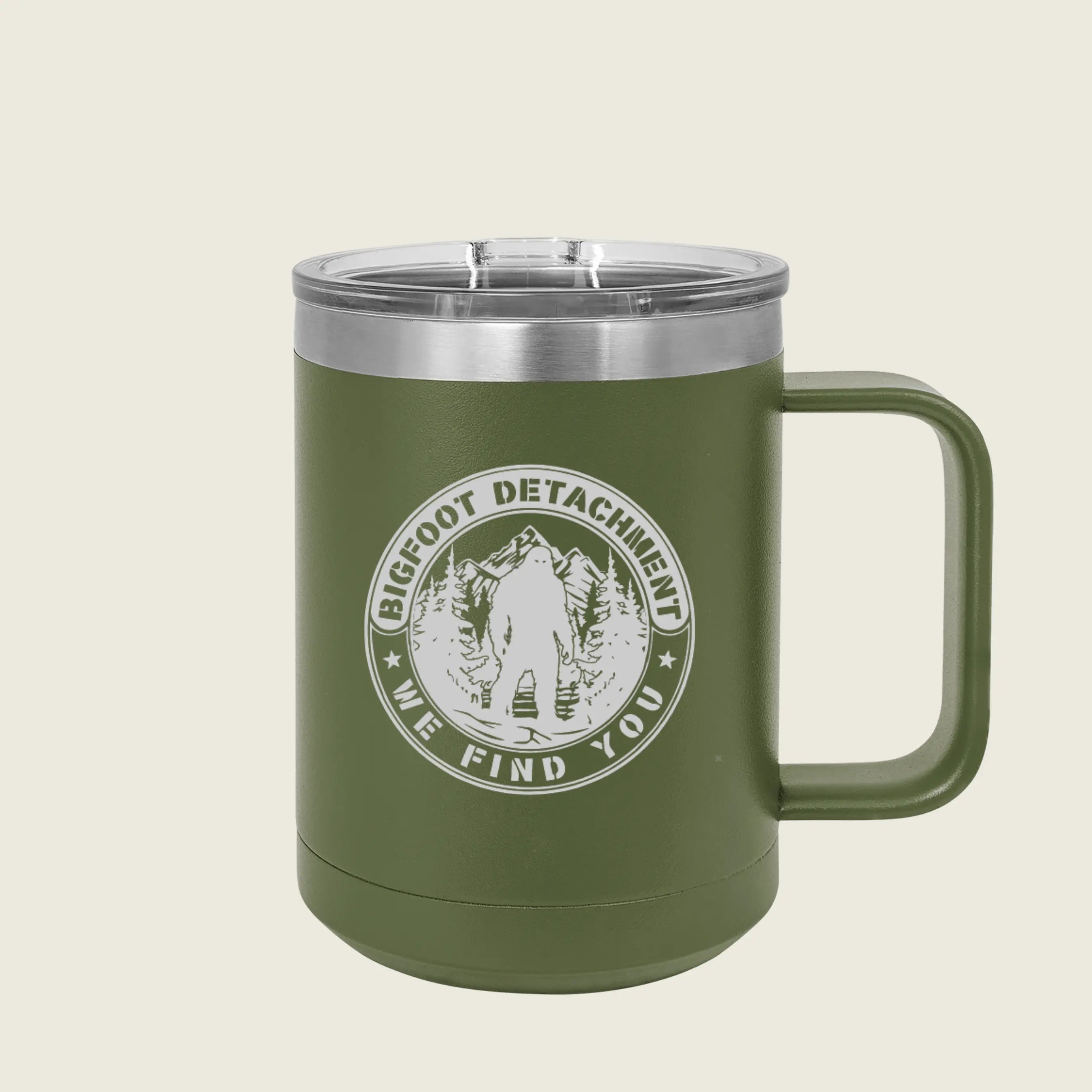 green coffee mug with bigfoot logo on a beige background