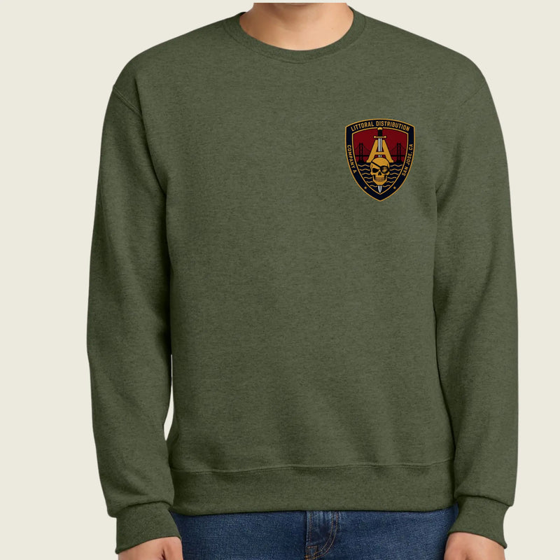 An olive green crewneck sweatshirt worn by a model, featuring amilitary logo on the left chest, set against a plain light beige background.