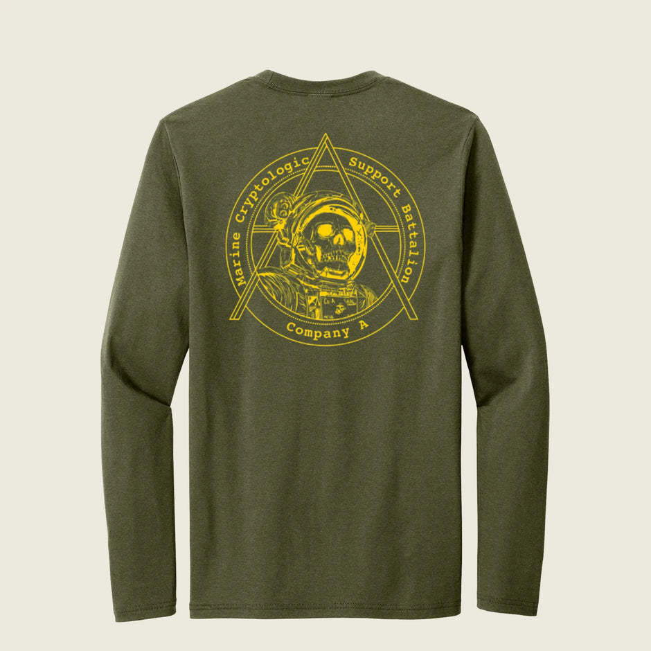An olive green long-sleeve t-shirt shown from the back, featuring a large yellow graphic print of an astronaut inside a geometric triangle emblem with the text 'Marine Cryptologic Support Battalion Company A'.