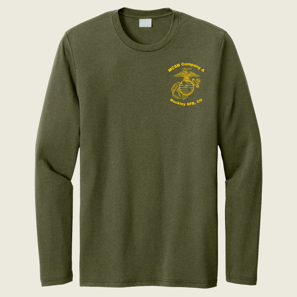 An olive green long-sleeve t-shirt with a yellow USMC (United States Marine Corps) Eagle, Globe, and Anchor emblem printed on the left chest, displayed against a light beige background.