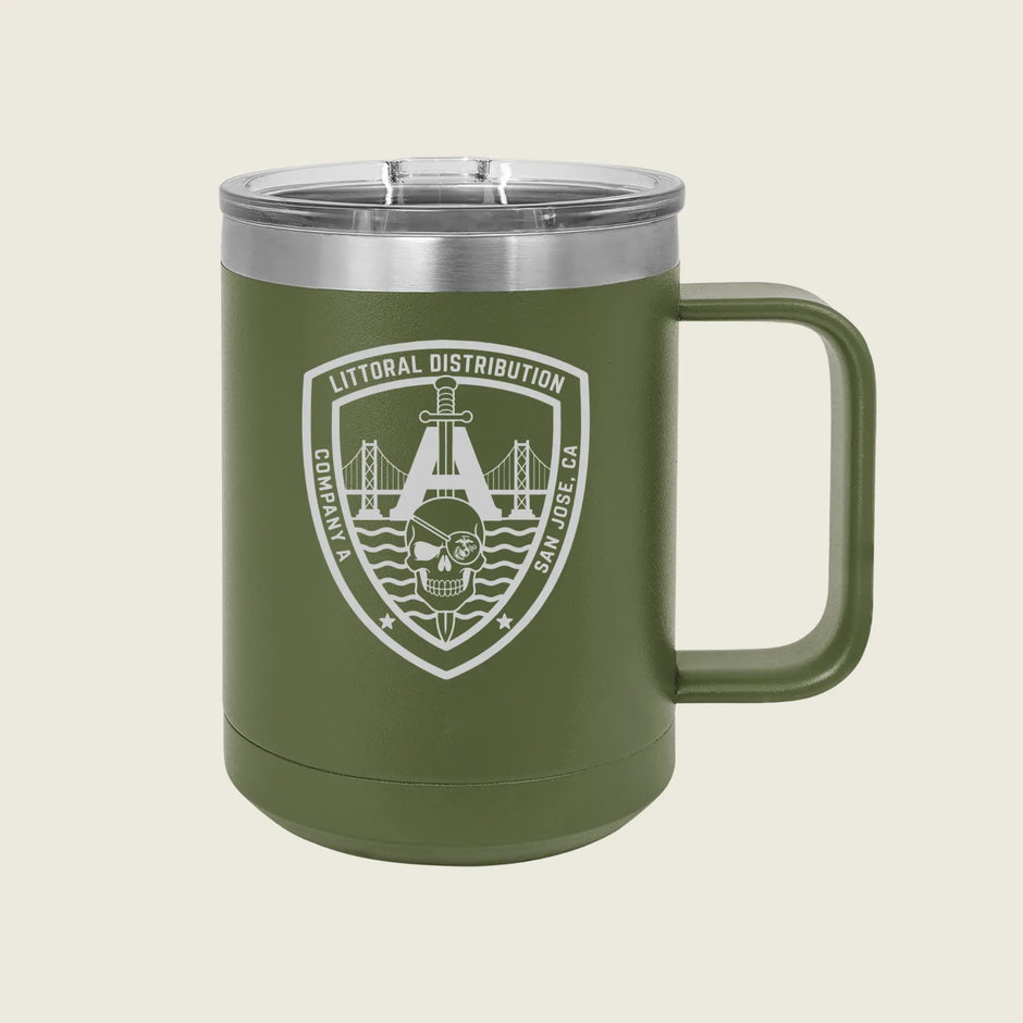 An olive green insulated tumbler with a clear lid and a white printed shield emblem on the front, shown against a light beige background.