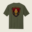 An olive green short-sleeve t-shirt shown from the back, featuring a large military-style crest graphic on the center back with a gold anchor, skull, bridge, and text reading 'LITTORAL DISTRIBUTION' and 'COMPANY A SAN JOSE CA'.